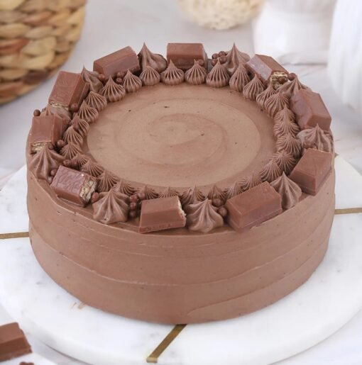 Delicious Kit Kat Crunch Cake featuring layers of cream and Kit Kat chocolate bars