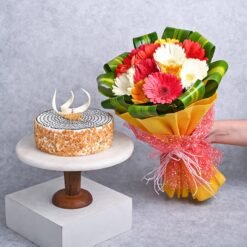 A colorful bouquet of fresh gerberas paired with a delightful cake, perfect for celebrations and joyful moments.